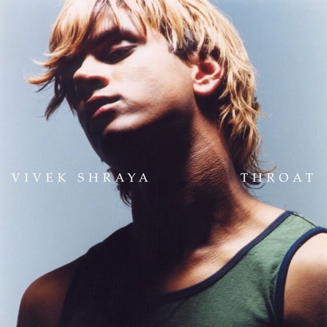 A head-and-shoulders photo of a brown-skinned person in their early 20s with blonde hair, wearing a green tank top against a blue background; their head is tilted back and their eyes are in shadow. White text across the centreline of the photo reads, “Vivek Shraya. THROAT.&rdquo;