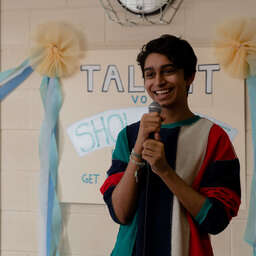 Vivek (Chris D’Silva) sings at the school cafeteria in 1997, in a still from How to Fail as a Popstar.